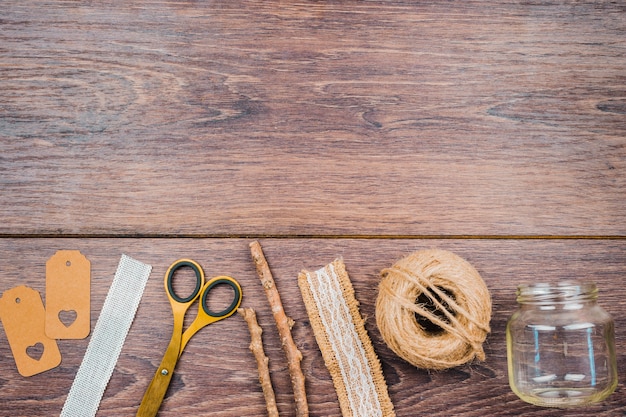 Threads and needles on wooden table